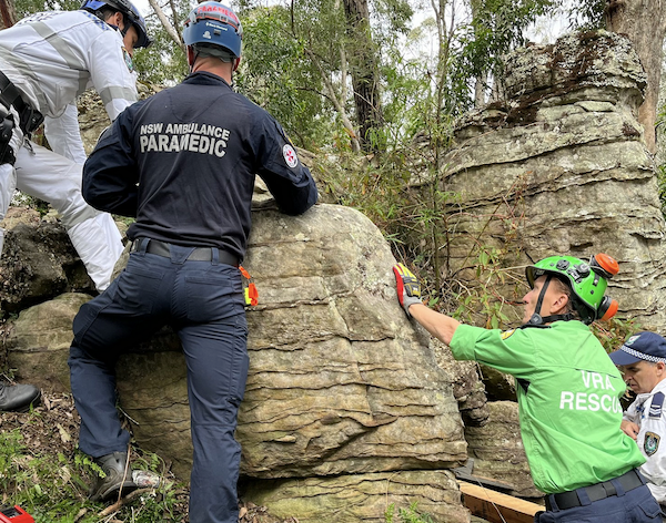 Workers trying to stabilize rocks to rescue trapped woman